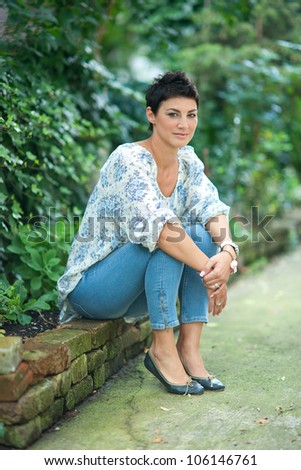 attractive brunette woman sitting outside