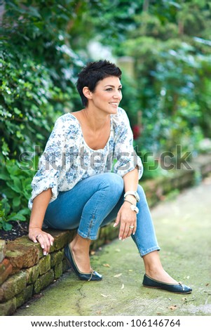 attractive brunette woman sitting outside