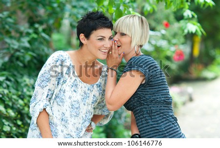 two woman friends chatting outdoors