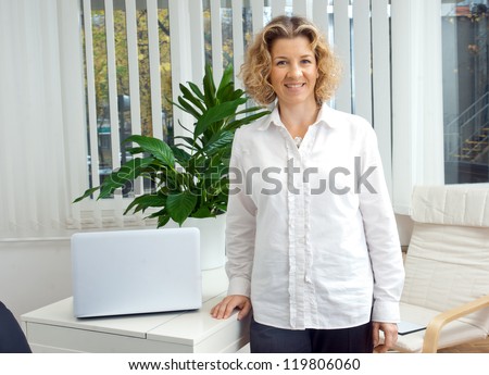 attractive middle aged woman in her office