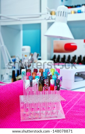 artificial nails on the stand in manicure salon