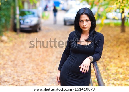 attractive black hair woman outside in the town park