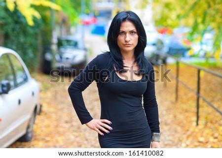 attractive black hair woman outside in the town park