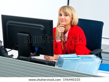 attractive seductive blonde business woman in office workstation with computer