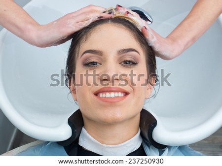 attractive woman having hair washed in salon