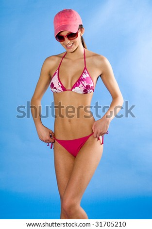 girl in swimsuit with sunglasses smiling