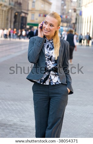 sophisticated woman talking to mobile phone in the street