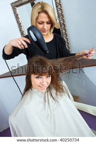 woman with wet hair in hair salon having treatment