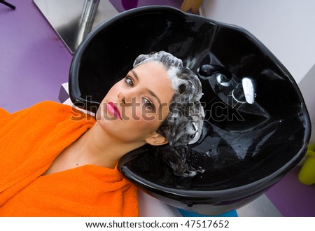 woman washing hair in pool in hair salon