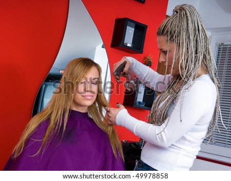 hairdresser sprey woman hair in salon