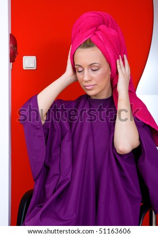 woman in hair salon with towel on her head
