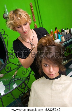 stylist work on woman messy hair in salon