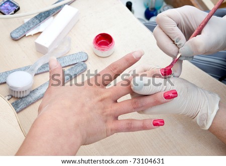 woman polishing finger nails treatment in manicure salon