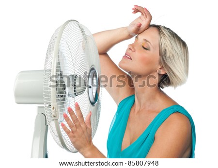 woman cooling herself with electric fan