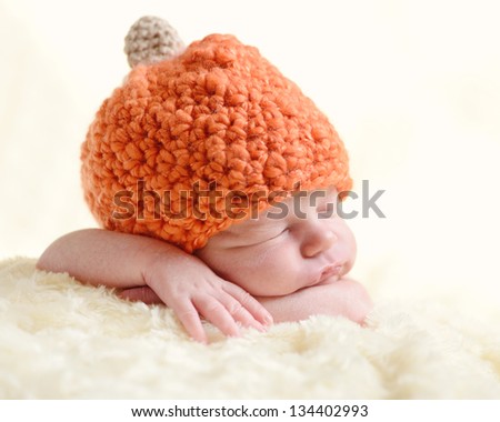 sweet newborn wearing orange hat