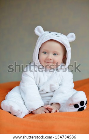 funny smiling  baby wearing costume of polar bear