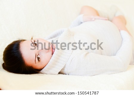 pretty pregnant woman  laying on the sofa