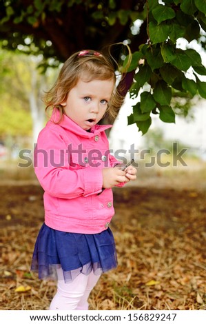 cute fashion toddler girl outdoors in fall time
