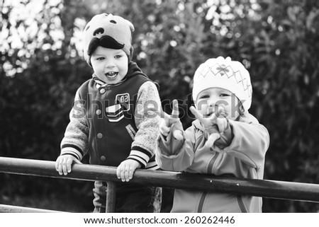 two funny children playing in the park