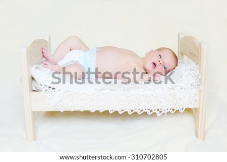 sweet newborn baby  on the little bed