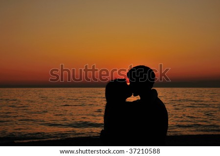 kissing couple on the beach with little peace of sun