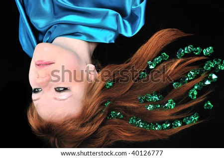 head of girl with natural red hair over black