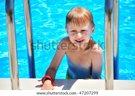 funny little boy coming out swimming pool