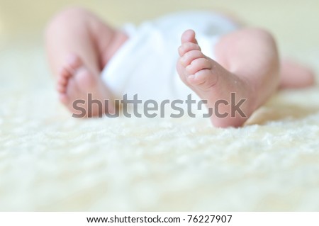 little foot of newborn baby in soft selective focus
