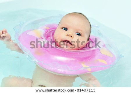 swimming two months old baby with neck swim ring