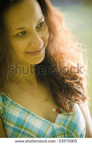 Young woman in retro garment hugging self. Romantic portrait with green mood. Focus on one eye.