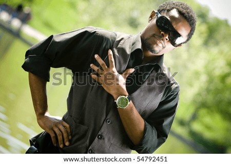 Young black man in casual clothing. Focus on watch.