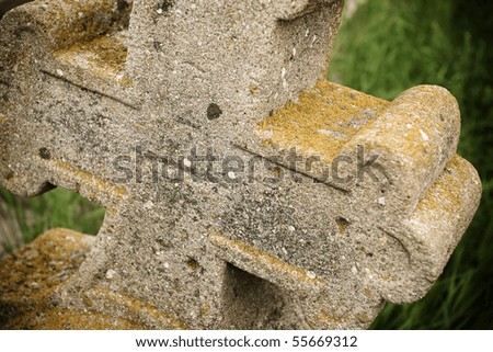 Abstract view of an abandoned rusty-old cross in a cemetery.