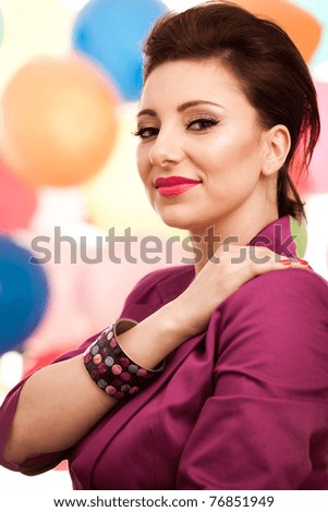Portrait of a lovely girl in front of a colored background. Professional makeup applied. See more images from the same shoot.