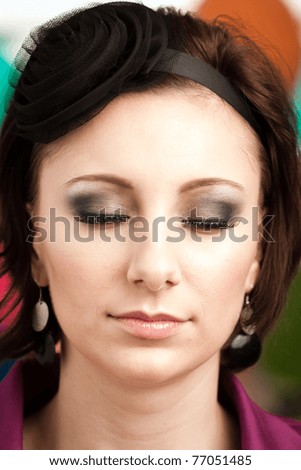 Closeup of a woman with professional makeup applied. See more images from the same shoot.