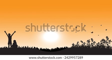 the silhouette of two small children happily welcoming the morning sun with a beautiful orange sky