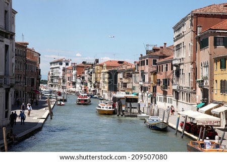 VENICE, ITALY -JULY 15: Gondolas and tourists on July 15, 2014 in Venice, Italy. Venice has an average of 50,000 tourists a day and was the 26th most visited city in the world.