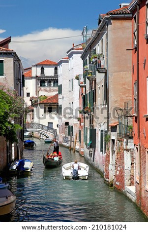 VENICE, ITALY - JULY 16: Tourists on a Gondola, July 16, 2014 in Venice, Italy. The city has an average of 50,000 tourists a day and it\'s one of the world\'s most internationally visited city