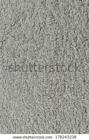 Grey natural plush terry cloth turkish bath / beach towel, textured fabric macro background closeup vertical texture pattern