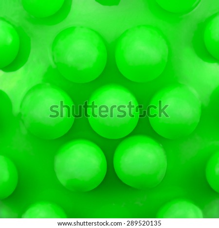 Dog teeth massage toy ball knobs pattern, large detailed green macro closeup, abstract plastic circles texture studio shot, canine dental care concept