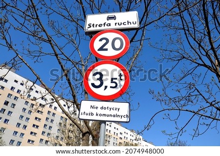 Road sign speed limit 20 and road sign 3.5t restriction of entry with subtitles in Polish - Traffic zone, Does not apply to municipal services Photo stock © 