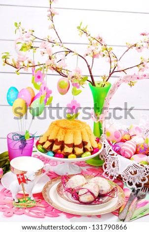 easter table decoration with marble ring cake and eggs in wicker basket