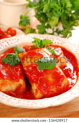Stuffed cabbage leaves rolled with minced meat and rice in tomato sauce as traditional polish dinner