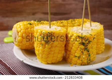 boiled sweet corn cobs with butter and herbs