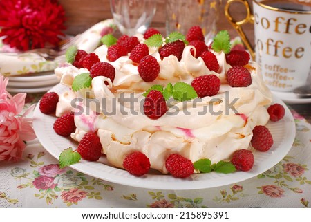 meringue  pavlova cake with whipped cream,caramel and fresh raspberries