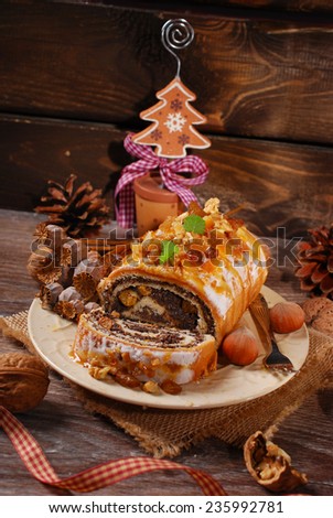 poppy seed cake with nuts and dried fruits for christmas on rustic wooden table