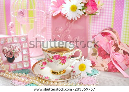 tea in fine china cup with roses ornament  in romantic style