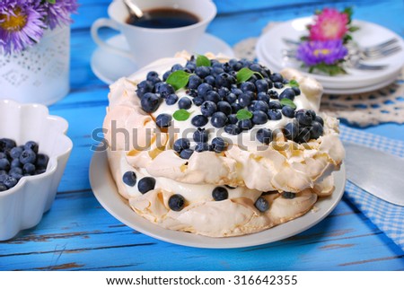 blueberry pavlova cake on blue wooden table