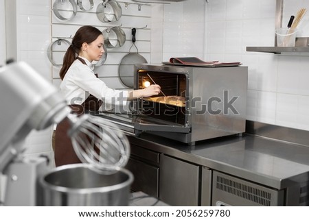 Similar – Foto Bild Männlicher Bäcker schiebt Kuchen in den Ofen