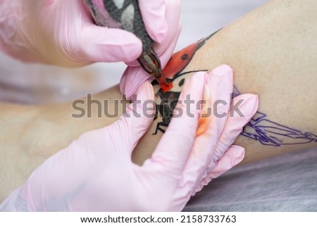 Similar – Image, Stock Photo Master doing tattoo on forearm of male customer