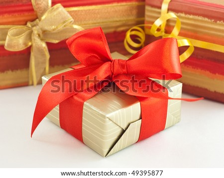 Gift wrapped present with red satin bow